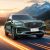 Geely Xingyue L SUV driving on a road with a mountainous sunset background.
