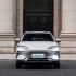 Front view of BYD Song Plus DM-i 2025 model, a silver SUV with distinctive Ocean X Face grille and sleek headlights, parked in front of a grand stone building.