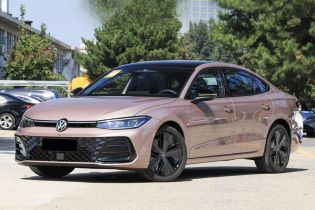 A pink Volkswagen sedan parked on a road, with trees and buildings in the background.