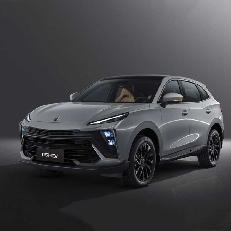 A silver T5 HEV SUV with black accents, showcased against a dark background, highlighting its modern design, illuminated headlights, and sleek black alloy wheels.