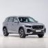 Front side view of a silver Geely SUV.