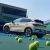 A light - colored BYD Yuan Plus electric SUV on a tennis court with tennis balls around.