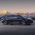 Side view of a dark blue NIO ET9 electric car with snow-capped mountains in the background.