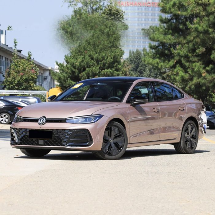 A pink Volkswagen sedan parked on a road, with trees and buildings in the background.