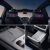 Interior details of a car, including rear seat screens, wireless charging, and a storage compartment.