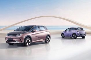 BYD Dolphin (rose gold, purple) in modern space; coastal backdrop with sailboats and arch structure.
