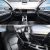 Interior of a car, showing the dashboard, front seats, and a spacious, modern design with a view of the sky through the windows.