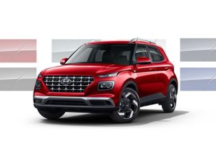 Three-quarter view of the front side of a red 2026 Hyundai Venue