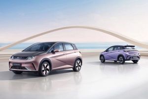 BYD Dolphin (rose gold, purple) in modern space; coastal backdrop with sailboats and arch structure.