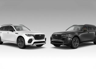 Side-by-side view of a 2025 Mazda CX-70 against a CX-90 background, showcasing contrasting color options