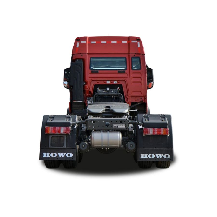 Rear view of a red HOWO truck tractor unit, showcasing its chassis and components, isolated on a white background.