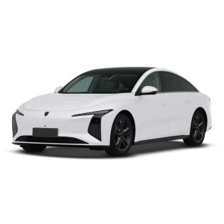 A white electric sedan with a sleek, modern design, featuring a black roof, distinctive headlights, and black alloy wheels, presented against a plain white background.