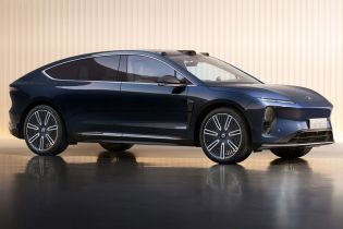 Side view of a dark blue NIO ET9 electric car in a studio setting.