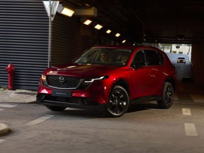 Red Mazda CX-5 SUV parked in dim underground parking lot