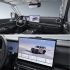 Interior of a car featuring a digital dashboard and a large central touchscreen displaying a vehicle image.