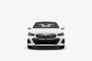 Head-on studio shot of new white BMW luxury car on plain background