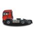 Side view of a red heavy - duty truck tractor unit, isolated on a white background.