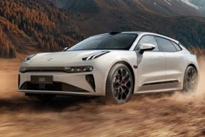 A white Zeekr 001 driving on a dusty terrain, with a backdrop of autumn forests and mountains, showcasing its dynamic off-road performance and sleek design.