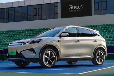 A light - colored BYD Yuan Plus electric SUV parked on a tennis court.