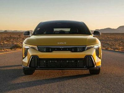 2026 Kia K4 Hatchback, parked in the middle of a desert road at golden hour, front-view