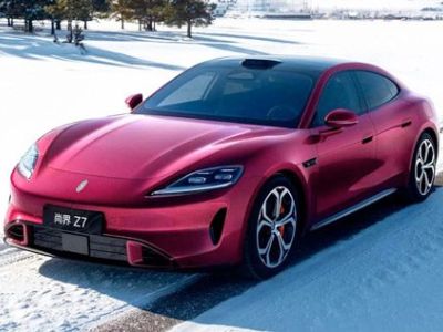 Sleek red all-electric sports sedan, the Xiaomi SU7, displayed on a snowy road, showcasing futuristic design and alloy wheels.