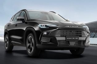 A black Jetour X70 Plus SUV driving on the road.