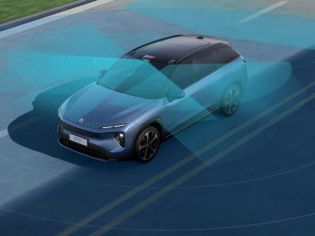 Blue electric SUV with a semi-transparent blue sensor field, showcasing advanced driver-assistance systems on the road.