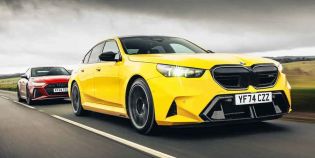 A yellow BMW (license plate YF74 CZZ) and a red Audi (license plate KY24 TEU) driving on a road.