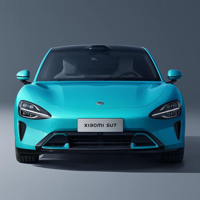 Front view of a turquoise Xiaomi SU7 car.