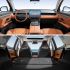 A look at the interior of a car, showcasing a sleek dashboard with a large screen, comfortable seats, and a spacious rear area.