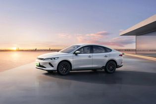 BYD electric sedan: Sleek white design, eco-friendly performance, and modern style for coastal drives.