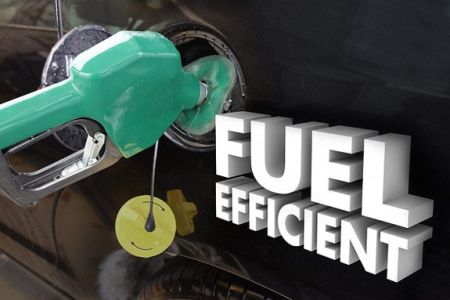 Close-up of a green fuel nozzle inserted into a car's fuel tank, with "FUEL EFFICIENT" text displayed.