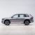 Side view of a silver Geely SUV.