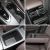 Four views of car interior storage spaces, including cup holders and compartments.