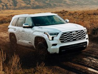 A 2026 Toyota Sequoia driving on a muddy road