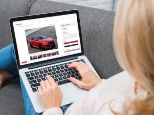 Browse cars online using a laptop