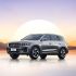 Geely Xingyue L SUV with a sunset and mountain background.