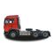 Side view of a red heavy - duty truck tractor unit, isolated on a white background.