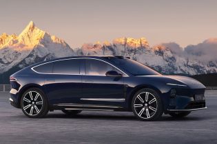 Side view of a dark blue NIO ET9 electric car with snow-capped mountains in the background.