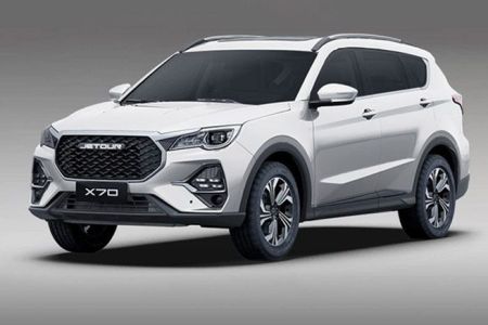 The Jetour X70 SUV, in a sleek white finish, features a bold grille, modern headlights, and stylish alloy wheels, embodying a blend of rugged design and urban sophistication.