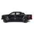 Side view of a black pickup truck with off - road tires, isolated on a white background.