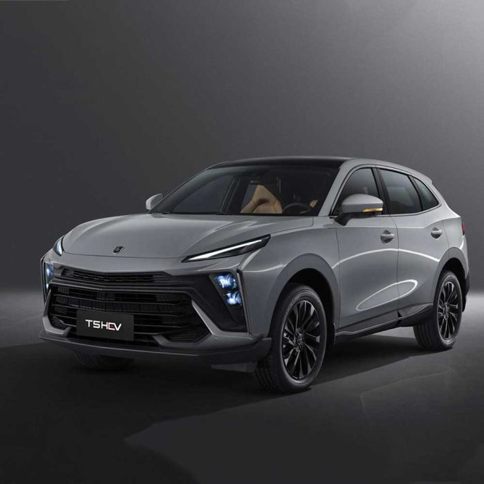 A silver T5 HEV SUV with black accents, showcased against a dark background, highlighting its modern design, illuminated headlights, and sleek black alloy wheels.