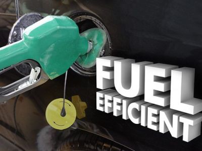 Close-up of a green fuel nozzle inserted into a car's fuel tank, with "FUEL EFFICIENT" text displayed.