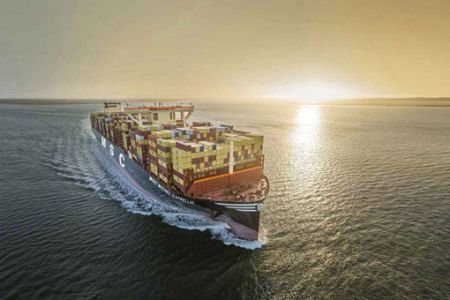 A large MSC container ship sailing on the sea during sunset.