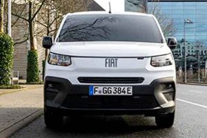 Front view of a white Fiat van with license plate F GG 384E, parked on a street in an urban area.