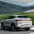 Silver BYD Song PLUS DM-i SUV (rear side view): Parked by a modern glass building and grassy hill. Features red "BYD" badge, taillights, and "Song PLUS DM-i 2025" label.