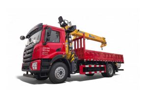 A red truck with a yellow crane mounted on its flatbed.