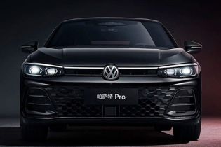 Front view of the black Volkswagen Passat Pro sedan, featuring illuminated headlights and a honeycomb grille, set against a dark background with red accents, highlighting its modern and bold design.