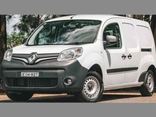 White Renault small van (license: EIH-92T) parked outdoors. Features Renault logo, black front bumper/trim, steel wheels. Background: trees, sunny paved area. Compact commercial vehicle design.