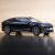 Side view of a dark blue NIO ET9 electric car in a studio setting.